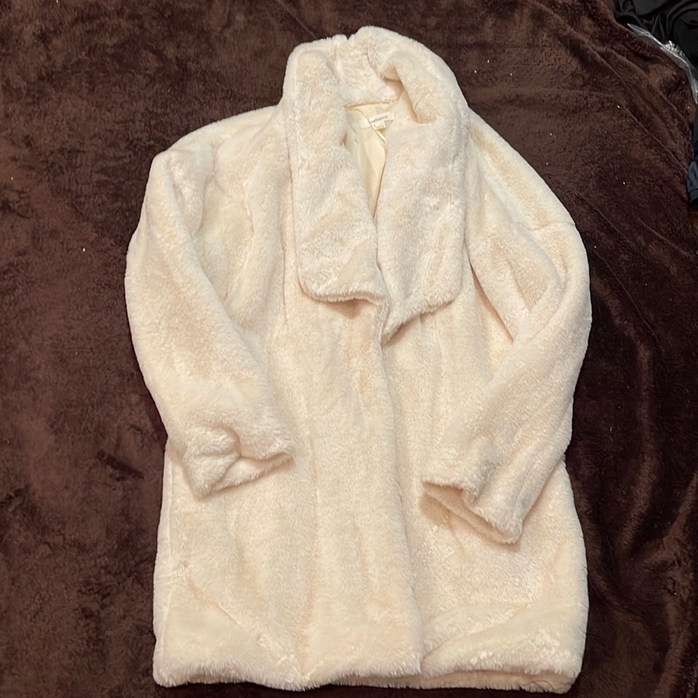 Cream fleece below the waist long sleeve coat. No buttons or zippers.